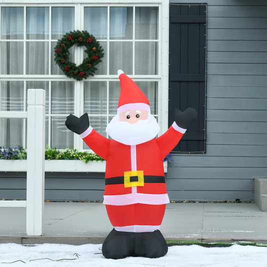 Inflatable Santa Claus decoration in front of a house with a wreath on the door.