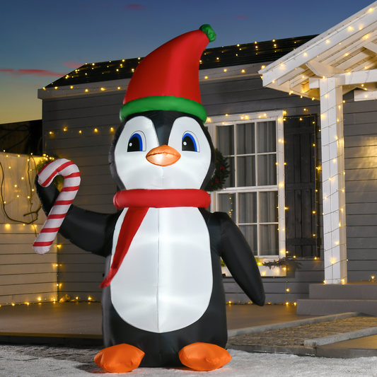 Inflatable penguin with a Santa hat and candy cane in front of a house decorated with lights.