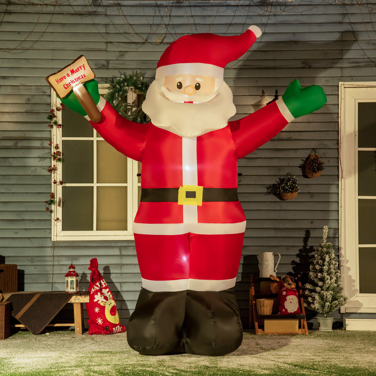 Inflatable Santa Claus decoration in front of a house with Christmas decorations.