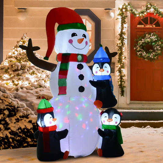 Inflatable snowman with penguins in front of a house decorated for Christmas.