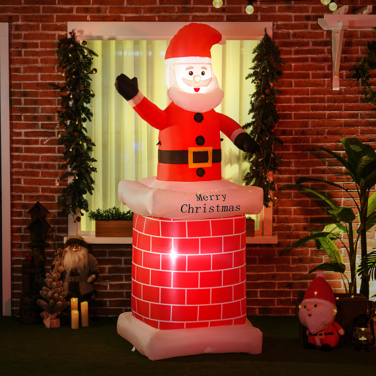 Inflatable Santa Claus decoration on a brick wall with Christmas decorations.