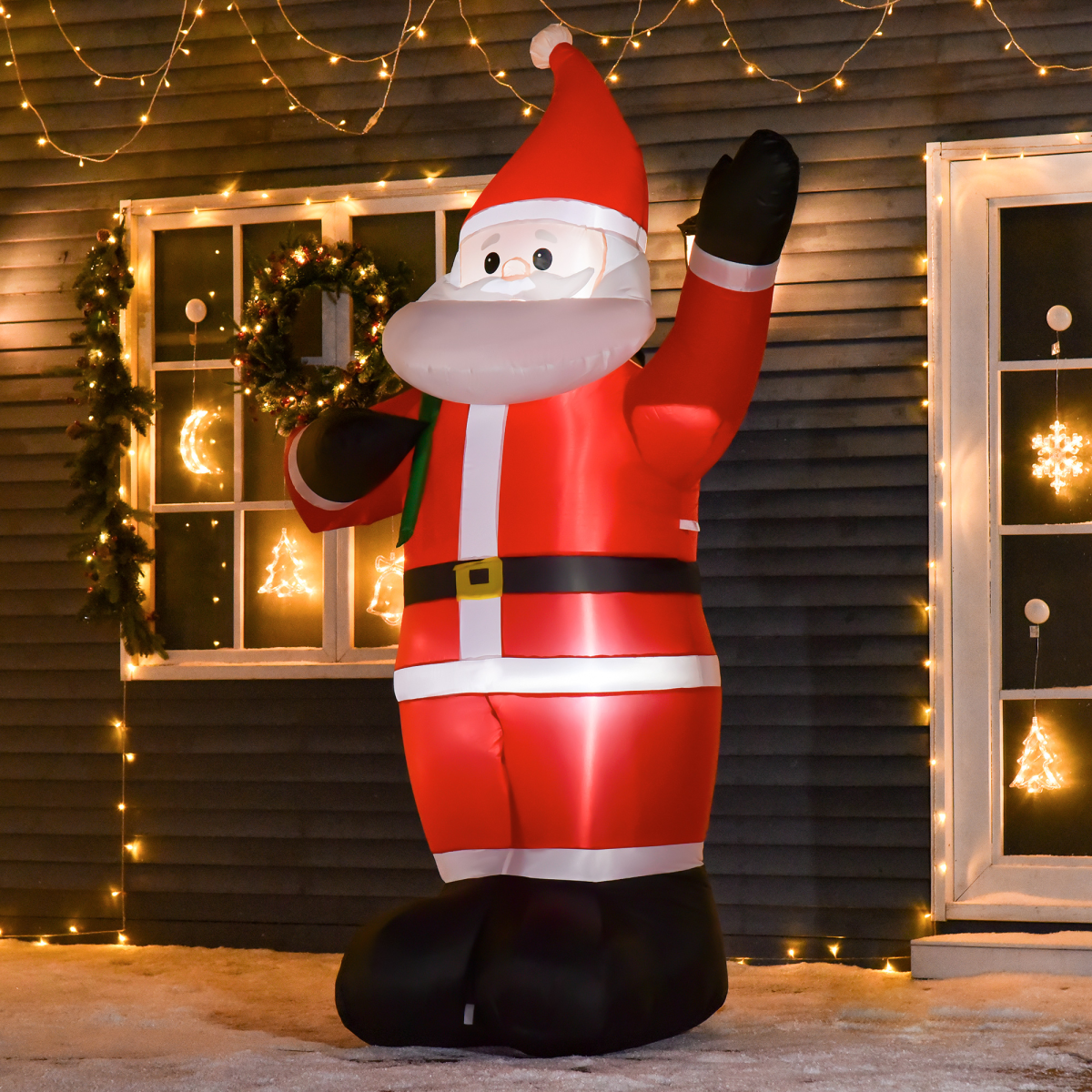 Inflatable Santa Claus decoration in front of a house with Christmas lights.