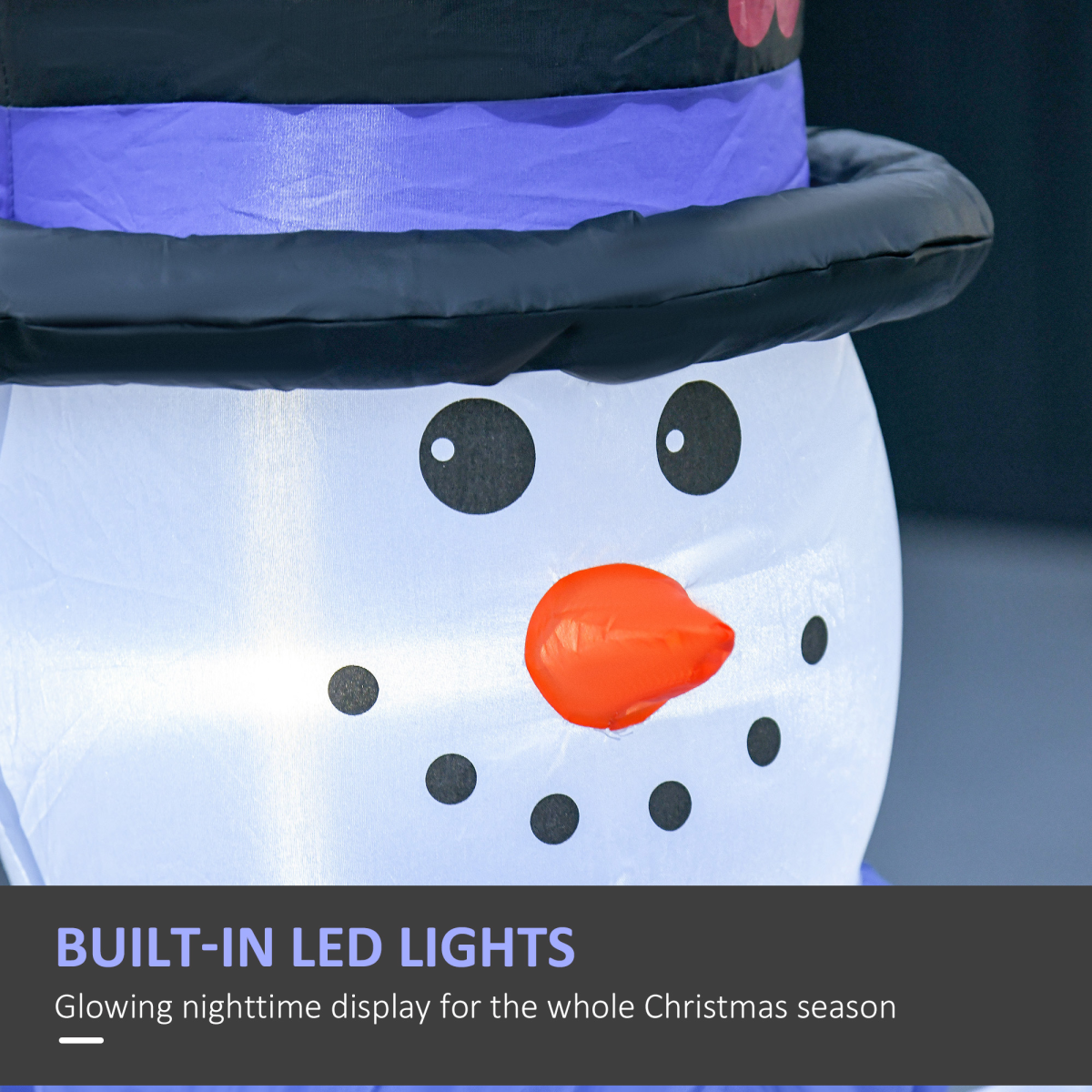 Inflatable snowman decoration with built-in LED lights on a dark background
