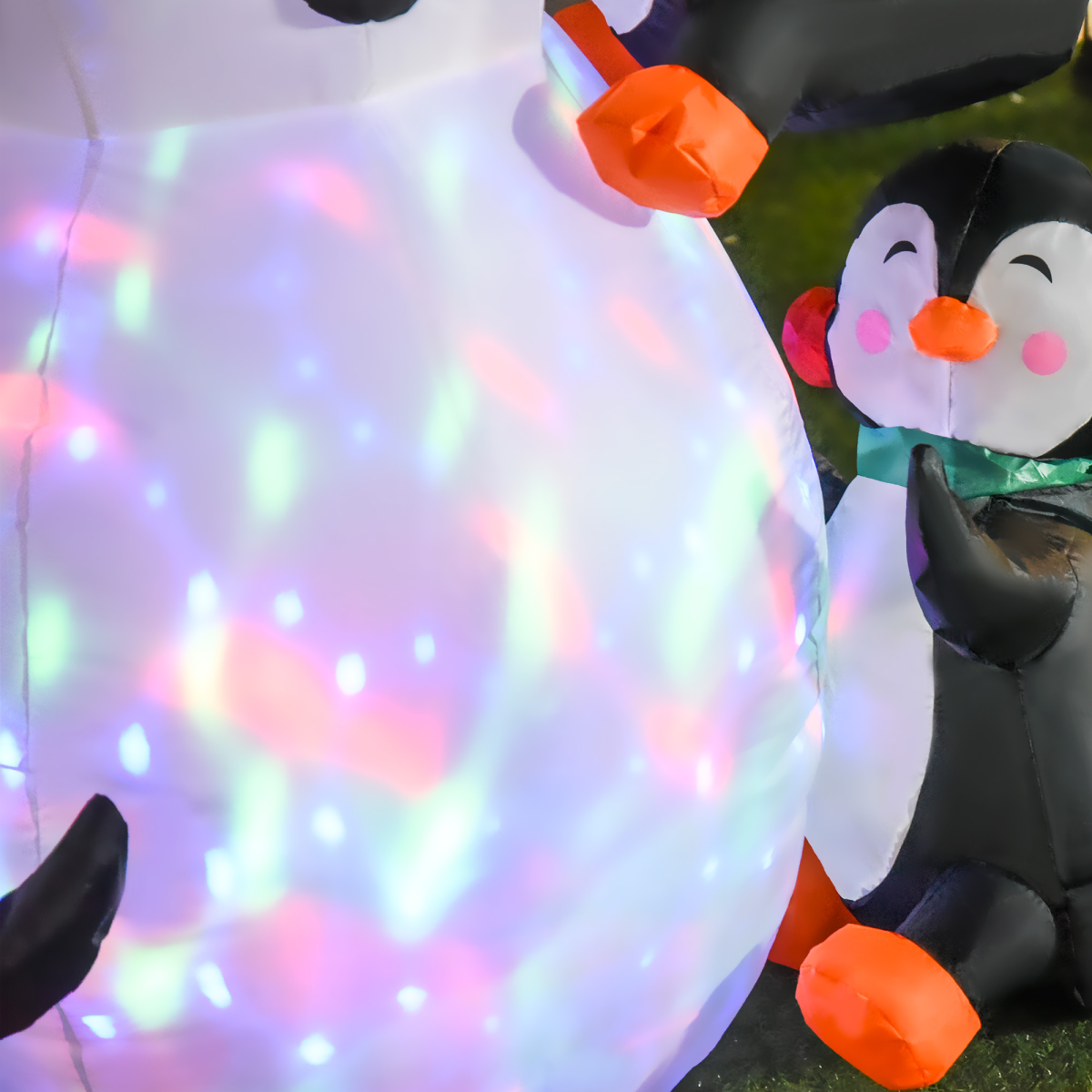 Inflatable penguin with colorful lights and another penguin in the background.