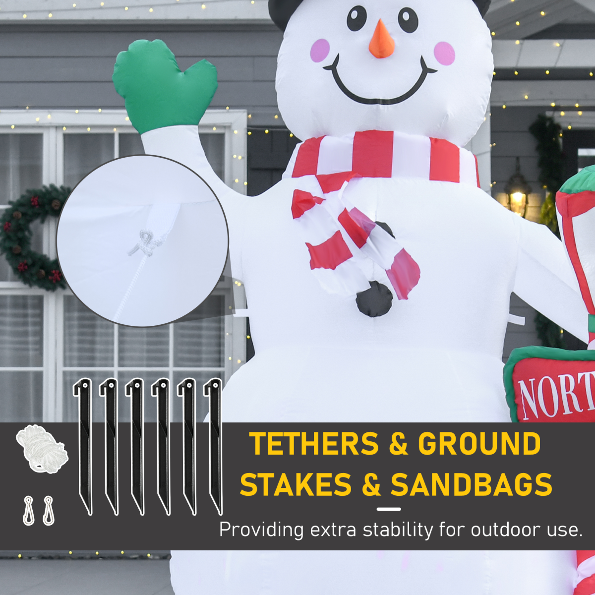 Inflatable snowman decoration with tethers, ground stakes, and sandbags for stability.